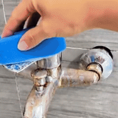 Cleaning demonstration showing buildup being removed from a faucet